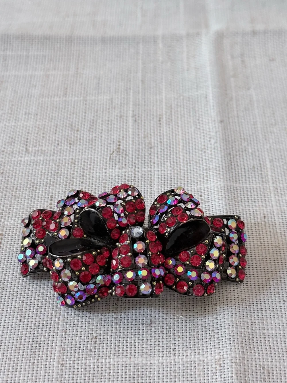 red rhinestone bow hair claw clip embellished with sparkling red and aurora bore